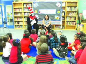 Assemblywoman Cristina Garcia reads to kindergarten students in the classroom of her former teacher Ms. Ponce-Edgington.