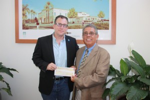 Matt Asner receives $10,000 donation from Sal Flores on behalf of the Irving J. Moskowitz Foundation for the non-profit organization Autism Speaks. The check presentation was done at the Hawaiian Gardens Bingo Club on Tuesday. Daniel E. Beckham Photo.