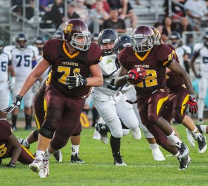 PHOTO BY MIKE ZOETEWEY Valley Christian sophomore right guard Eric Schoonover provides ample room for senior running back Jonathan Nicholson to pick up some yards in last Friday night's season-opening 50-6 win over Duarte. Nicholson rushed for 146 yards on 16 carries and scored four touchdowns.