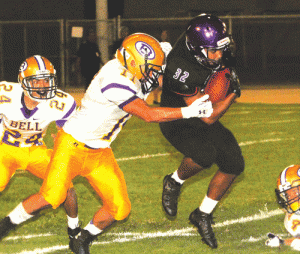 Norwalk senior running back Chris Walker, in his first game since the seventh game of last season, tries to elude the grasp of Bell's Joshua Zelaya in last Friday night's 34-14 opening season victory at Excelsior Stadium. Walker picked up a game-high 170 yards on 16 carries and scored three touchdowns.