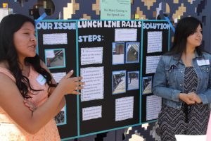 Students Sandra Villanueva, left, and Bethany Vela explain the steps they took to develop and propose a solution that would better control the lunch lines at the Schurr High School cafeteria during the Civic Action Project Showcase at La Plaza de Cultura y Artes.