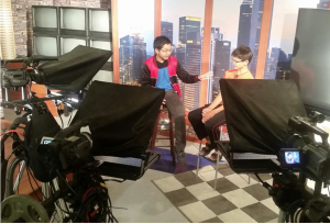 ACTION! Reporter interviews subject on the set after the third stage dressing of the day. Each setup requires different lighting, sound checks, and camera angles. Students learn how the technical setup is just as important as the story on their documentary productions in the ABC Education Foundation Summer Enrichment Program, Video Production Workshop.